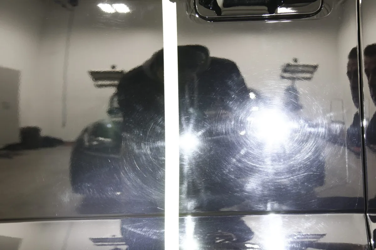 Swirled paint under inspection light before correction