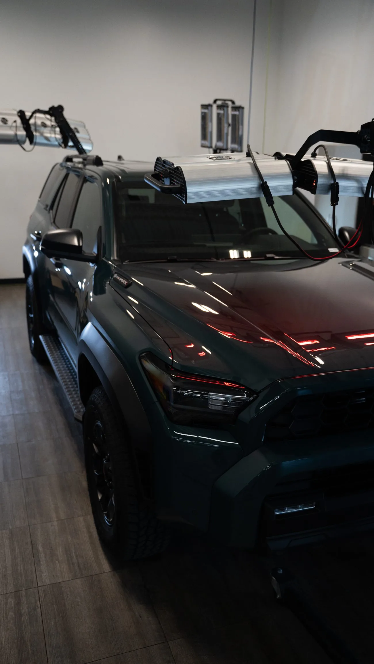 Coated SUV curing under infrared lamps in the coating bay